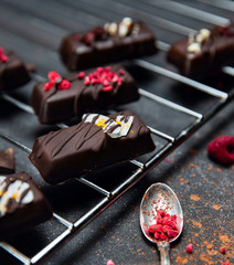 Chocolate candies without sugar on the kitchen grill. Raw vegan chocolate candies. Lactose free candies. Gluten free candies. Without artificial dyes chocolate.