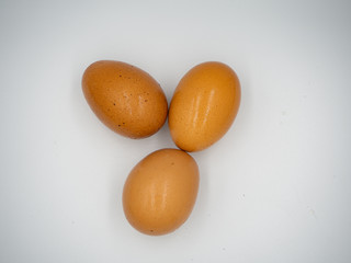 The top shot of three eggs with white background