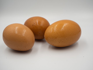 Close up shot on the three eggs that placed on the white background