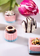 Chocolate candies without sugar on the white background. Raw vegan chocolate candies. Lactose free candies. Gluten free candies. Without artificial dyes chocolate.