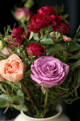 Bouquet with different flowers  in the vase at the home. Amazing smell from the flowers.