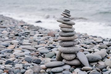 stones on the beach in the shape of a pyramid. balance and meditation, space for text