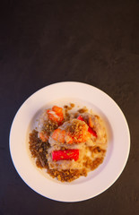 Steamed minced pork dumplings with sweet sauce in dish on  black background. select focus  topview