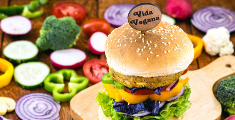 vegan snack, meatless hamburger, with small plate written in English Vegan life, gluten free, made with different vegetables and proteins. Vegetarian, healthy lifestyle.