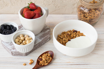 Granola with yogurt, nuts, strawberries and theiryum, delicious healthy breakfast
