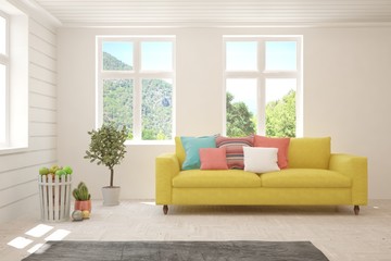 Fototapeta premium White living room with sofa and summer landscape in window. Scandinavian interior design. 3D illustration