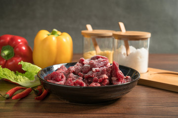 Raw beef with wooden table background