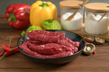 Raw beef with wooden table background