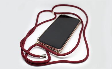 Smartphone in transparent case crossbody with red long textile strap, comfortable usage of mobile phone protective accessory