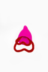 Pink menstrual cup from medical silicone with red heart shaped decoration, female love cycle , eco and zero waste concept at isolated background 