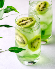 Glass of Refreshing Tropical Kiwi Lemonade With Ice on Light Gray Background Tasty Summer Beverage Healthy Detox Diet Drink