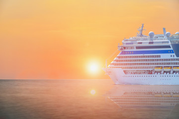 Cruise ship, large luxury white cruise ship liner sailing in the sea with sunset background