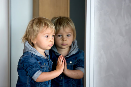 Reflection Of A Cute Little Toddler Boy, Child, Looking In Mirror