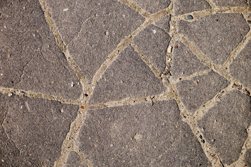 Obraz premium The texture of the broken road. Old building blocks. Background for screensaver monitor