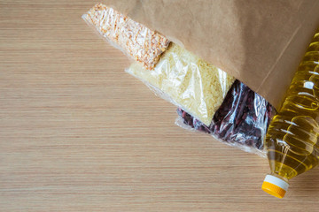 cereals in a package, and sunflower oil in a bottle, lying on the kitchen table