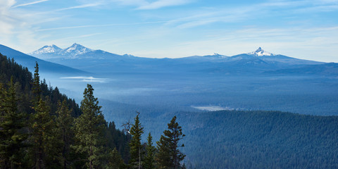 Morning panoramic view with Sisters mountains and Mt Washington from Green Ridge Lookout in central Oregon.