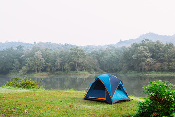 Camping tent by a lake with mist at sunrise Jetkod-Pongkonsao Natural Study in Saraburi Thailand	