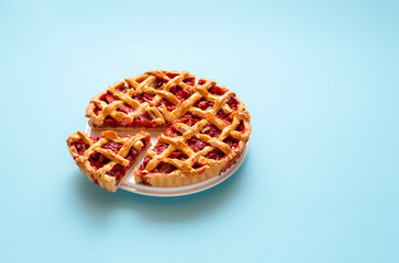 Rhubarb pie with a lattice crust on a plate. Sliced sweet pie