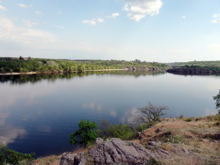 Unique landscape of the water mirror of the calm Dnieper, which carries its waters between the islands of Khortytsia and Baida against the spring blue sky.