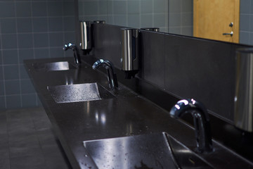 row of washstands in a public toilet.