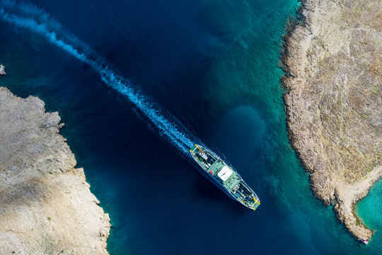Top view of  car ferry in Croatia. View of the island Rab, on the route between Stinica and Misnjak. On this side the island is rocky with sparse vegetation. South Europe