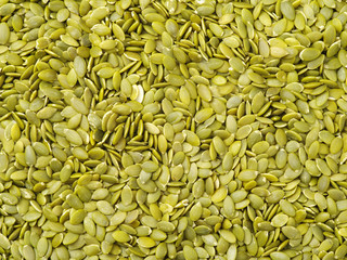 Macro background texture of green pumpkin seeds