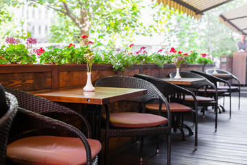 Interior of a summer playground without people with fresh flowers in pots. A cozy cafe.