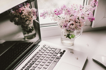 self-isolation workplace, computer and beautiful flowers - 350935964