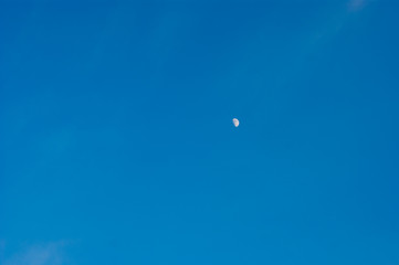 The growing moon or crescent moon is on a canvas of blue clear sky. Earth satellite, space.