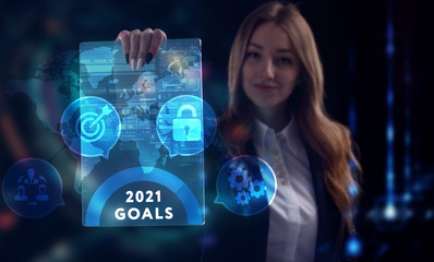 Business, Technology, Internet and network concept. Young businessman working on a virtual screen of the future and sees the inscription: 2021 goals