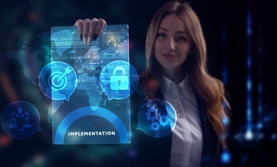 Business, Technology, Internet and network concept. Young businessman working on a virtual screen of the future and sees the inscription: Implementation