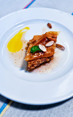 Turkish baklava dessert on white plate reflex