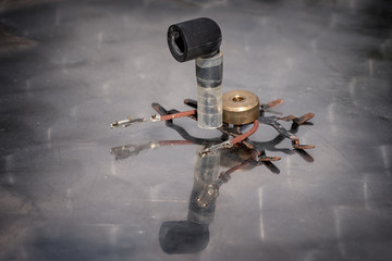 Bug robot from spares on a reflective table. Robotics lesson STEM education. Science concept.