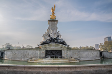 Statue outside Buckingham Palace, with running waterfall London England.