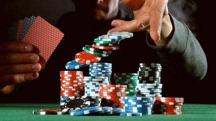 Poker player throwing chips - obrazy, fototapety, plakaty