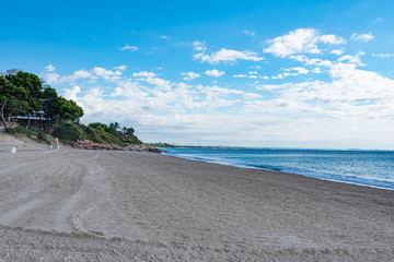 Sand beach with turquoise ocean during summer in Miami Platja, Tarragona, Catalunya, Spain. Copy...