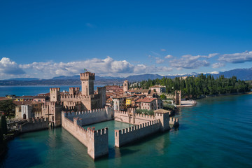 Sirmione Castle, Lake Garda, Italy. Aerial view of Sirmione. In the background mountains in the snow and blue sky.