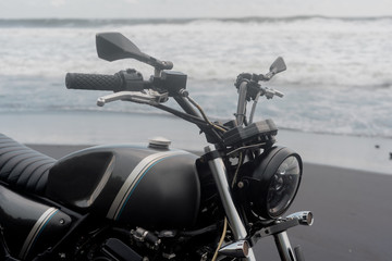 black motorcycle on the background of the ocean