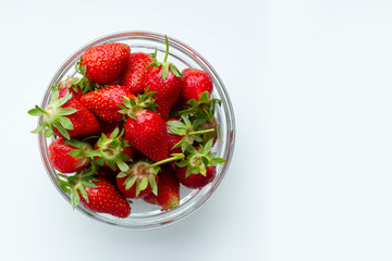 Strawberry in a plate on a white background. Strawberry top view.