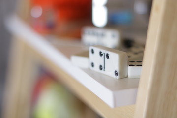 Variation of different objects including a camera and red glass box 
 and Wristwatch and flowers and domino on white background at home with nice depth and blur