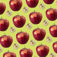 Creative layout, isolated fruit. Seamless pattern of red apples, pieces of fruit on a green background.Healthy food concept.