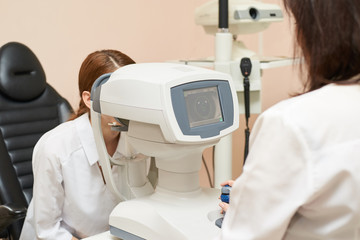 ophthalmologist doctor in exam optician laboratory with female patient. Eye care medical diagnostic. Eyelid treatment