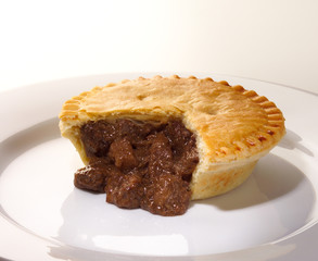 Cut open Steak and Kidney Pie on white plate