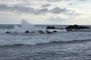 Stormy sea during a storm near Paphos, Cyprus. The waves crash against the rocks that protrude from the sea. The droplets fly up to two meters high. Abstract. The power of the ocean
