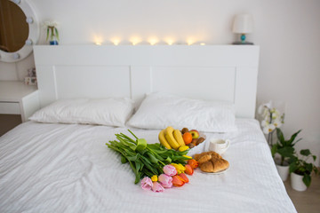 breakfast on a tray in a white bedroom