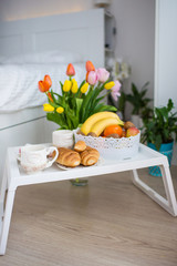 breakfast on a tray in a white bedroom