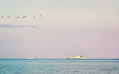 Naklejka premium Ship in Mediterranean sea at Santa Teresa di Riva Messina reflex