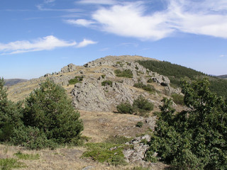 Fototapeta na wymiar Stone hill with a nice blue sky and clouds. 