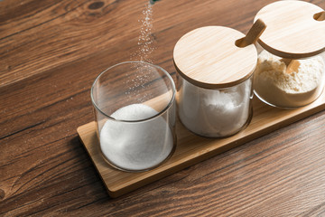 Condiments in the glass bottle on wooden table