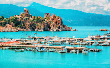 Cefalu port and Old castle ruins in Mediterranean sea Sicily reflex